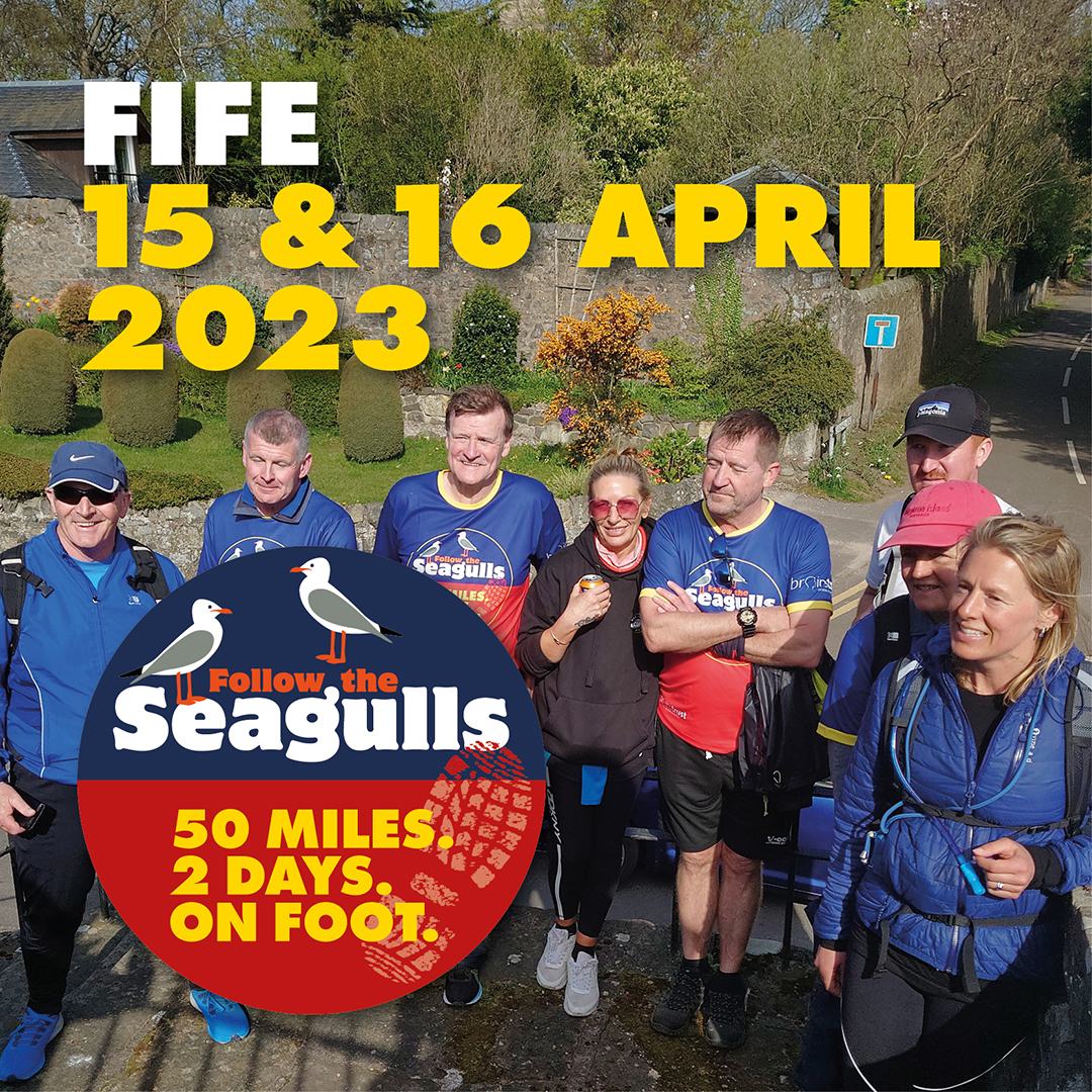 Text reads: Fife. 15 and 16 April 2023. ID: group of charity walkers wearing follow the seagulls t-shirts stood in green park.